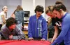 Eighth-graders Jackson Maloney, Noah Nix, Kamryn Broach and Reese Sande tie fleece blankets at Wasilla Middle School on Friday, Dec. 11. CAITLIN SKVORC/Frontiersman.com