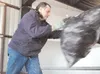 RUSSELL STIGALL/Frontiersman A full trash bag is no match for
the pitching arm of Bob Smith of Wasilla. Smith emptied several
bags from the back of his pickup at the Central Mat-Su landfill
T