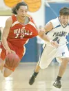 Palmer sophomore Brennan Bohman grabs at Wasilla senior Adrese
LaVern during Palmer’s win over Wasilla in February. Both teams
begin Northern Lights Conference tourney play on Thursday. ROBER