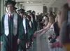 Spectators at the Colony High School graduation ceremony Tuesday
evening lean over the railing to slap hands with the graduates in
the class of 2011 as they walk along the top floor at the Cu