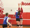 Palmer setter Tiana Lee tries to tip the ball past Wasilla's Olivia Vincent during Wasilla's 3-2 win over Palmer Oct. 27 at Wasilla High School. Wasilla is the No. 2 seed in the Northern Ligh