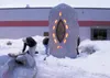 Mat-Su Borough School District employees remove tarps Friday
that had been covering a large sculpture in front of Wasilla High
School. GREG JOHNSON/Frontiersman