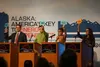 Candidates for Alaska’s U.S. House seat, appearing at an Aug. 31 forum held at an Alaska Oil and Gas Association conference, hold up signs to show their position on the Infrastructure Jobs an