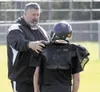 Norm Bouchard, a Houston football coach since 1997, talks with a
young player during an early-season practice. (JEREMIAH
BARTZ/Frontiersman)
