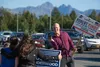 State Senate candidate Robert Yundt takes a photo of State House candidate Jubilee Underwood and volunteer Laci Jacques along the Parks Highway and Palmer-Wasilla Highway intersection Tuesday
