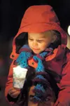 A participant holds a candle during last month’s candlelight
vigil at the Palmer Train Depot. Dozens gathered to show support
for homeless teens in the Valley. (Frontiersman file photo) Rober
