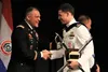 Coast Guard Lt. Nathan M. Borders, right, is congratulated by Army Col. John De Suggs Jr., as Borders receives the Gen. George C. Marshall Honor Distinction, a Master in Operational Studies, 