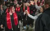 Destinie Boltz gets a 'high-five' during her entrance into the Menard Center from Brook Adams and her father Michael Boltz. J. David McChesney/Frontiersman