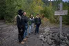 U.S. military first-term service members from Joint Base Elmendorf-Richardson, Alaska, observe at a sign informing them on which direction to continue their hike at Homer, Alaska, Sept. 11, 2