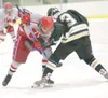 ROBERT DeBERRY/Frontiersman Wasilla Warrior Matthew Friese faces
off against South Anchorage Wolverine Brad Schierhorn during the
second period of Thursday game at ASAA First national Cup Sta