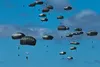 U.S. Army paratroopers with the 3rd Battalion, 509th Parachute Infantry Regiment, 4th Infantry Brigade Combat Team (Airborne), jump onto a drop zone as part of a simulated Joint Forcible Entr