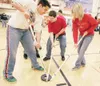 ROBERT DeBERRY/Frontiersman Competitors in the Special Olympics
Alaska School Program High School Unified Floor Hockey Challenge
battle for control of the puck during a game Friday morning at
