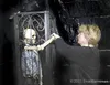 Linda Lockhart adjusts the arms of a caged skeleton prop at the
Pirates of Dollar Lake adventure in Big Lake. (ROBERT
DeBERRY/Frontiersman) Robert DeBerry