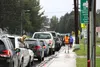 Dozens of cars lined up along Gulkana Street in Palmer to pick up students at Swanson and Sherrod Elementary on Monday after school bus service for regular education students was canceled. Ti