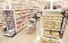 ROBERT DeBERRY/Frontiersman Shoppers walk the wider aisles
Friday created by a 10,000-square-foot addition to the Wasilla Fred
Meyer store.