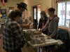 Friends of the Wasilla Public Library volunteer Heather Littau, right, talks to customers about the Friends' annual used book sale and fundraiser for the library at the American Legion in Was
