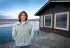 Daina Mirsch-Wenner stands on what is left of her and her husband Chris Wenner’s property in the Butte. In July, the Matanuska River began eroding their property, including a small cottage. N