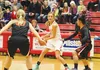 Wasilla senior guard Machia Toews keeps the ball away from West Anchorage High School players in the first half of their game Friday evening, the first of the season. The women Warriors beat 