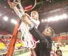 ROBERT DeBERRY/Frontiersman Jason Marvel, right, cuts down the
Sullivan Arena net with the help of his 9-year-old daughter Mariana
after his Wasilla Warriors boys’ basketball squad won the
la