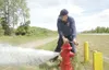 ROBERT DeBERRY/Frontiersman Central Mat-Su Station 61
firefighter Ken Hutchings releases water Thursday from a hydrant
along the Palmer-Wasilla Highway near Knik-Goose Bay Road.
Hutchings was