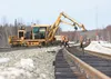 Workers use specialized heavy equipment to build a new section of track in Segment 6 of the Port MacKenzie Rail Extension that will connect the main Alaska Railroad line to Port MacKenzie via