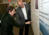 Audrey Lewis, 673d Air Base Wing Judge Advocate chief of labor law, and Jon Scudder, 673d Civil Engineer Squadron installation mission sustainment team manager, look at a poster during an Air