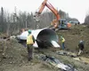 Kopperud Transportation Inc. laid the 10-foot-wide half dome
pipe at Settlement Avenue last week. The culvert had to be replaced
to allow juvenile coho salmon to swim upstream into a wetland
