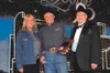 Charlie Willis, center, holds the coveted Top Hand Award
presented to him at a recent ceremony in Denver. Willis is flanked
by his wife and business partner, Nancy, and Gene House, president
