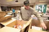 Volunteer Doug Bartko fills a Thanksgiving gift box Monday morning in Ping-Tung Chang’s classroom at Matanuska-Susitna College. The group of roughly 10 students and staff began gathering dona