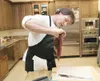 ROBERT DeBERRY/Frontiersman Carlile Transportation driving
instructor Phil Kromm inspects a piece of caribou during a recent
Allen &amp; Petersen Cooking and Appliance Center cooking
class.