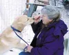 Tigger gets a treat from Carole Shay, who is training her to be
a service dog. Tigger held a man until police arrived last week.
Photo by CASEY RESSLER/Frontiersman.