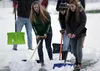 A group of Colony High School soccer players push snow across the turf during a team practice Monday afternoon. Knights head coach Jeremy Johnson estimates a group of about 35 players have pu