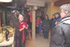 Dressed for an evening of dark mysteries, Carol Horner, left,
shares some of the history of her unique Colony-era home with its
add-on basement, where she hosted those who participated in the