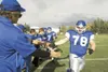 ROBERT DeBERRY/Frontiersman Palmer lineman Ben Self slaps hands
with his team as he takes the field at Palmer High School. This is
the second straight year Self has been voted a first-team al