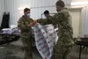 U.S. Soldiers assigned to 509th Clearance Company fold blankets for Afghans arriving at Fort McCoy, Wisconsin, Aug. 26, 2021. The Department of Defense, through U.S. Northern Command, and in 