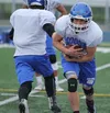 Palmer High senior Larry Cutsforth takes a handoff in a team practice sessioin during the second day of the 26th annual All-Alaska Football Camp at Palmer High School in June. Cutsforth led t