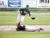 Anchorage’s Daniel Sisdorf slides underneath Mat-Su infielder Nash Knight as the ball bounces over Knight’s shoulder during the third inning of the Miners’ game against the Bucs Monday at Her