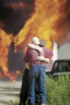 Paul Felthauser hugs his 84-year-old father, Donald, as their house burns to the ground off Winding Brook Loop Friday afternoon. The residential fire brought crews from Palmer and Central Mat
