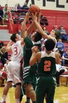 Wasilla's Kobe Burns and Isaac Houck battle for a rebound during a loss to the Mesa Verde Mavericks Dec. 30. JEREMIAH BARTZ/Frontiersman