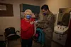 U.S. Air Force Tech. Sgt. Orlando Navarro II, the 673d Healthcare Operations Squadron Allergy and Immunizations Clinic noncommissioned officer in charge, administers the first of a two-dose s