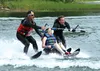Palmer student Taylor Thompson, soon to be a freshman in high school, comes in from water skiing on Finger Lake with the assistance of Challenge Alaska volunteers Mike Caselle, left, and Nate