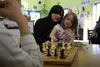 Brandi Kinney and her daughter Amethyst play chess with Michael Cebrian at a Sept. 9 My Voice event at MY House in Wasilla. My Voice is a youth storytelling initiative guided by former Fronti
