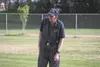 Bim Hoylman looks toward first base as he prepares to make a call during a Palmer Little League game Tuesday night. Hoylman, who is known by many in Palmer as a friendly bagger from the Carrs
