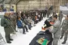 U.S. Air Force Senior Airman Zachary Crosier, air crew flight equipment journeyman with the 3rd Operation Support Squadron, explains the uses of arctic survival gear during an air attaché tou