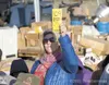 Valley resident Darcy Wison-Quam raises her hand to raise the
bid on a toy airplane during Saturday's auction. Wilson-Quam won
the item with a high bid of $45. (ROBERT DeBERRY/Frontiersman) R
