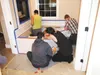 The Construction Trades program is in the final stages of building the house. Members of the program work to apply the grout in between the tiles of the master bathroom tub. Photo courtesy of