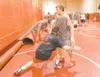 ROBERT DeBERRY/Frontiersman Wasilla wrestling coach Shawn Hayes
works with freshman wrestlers Tyler Adams, left, and Jeremy Carter
during Monday's Practice.
