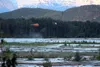 A pair of helicopters circle above the Matanuska River near Palmer late Tuesday night searching for a woman and child who had fallen into the water near the Old Glenn Highway Bridge earlier i