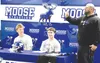 Palmer football head coach Tim Popowski, right, speaks about Moose seniors Nolan Garner and Reed Craner before the pair signed their National Letter of Intent to play football at Dickinson St