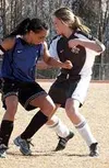 Palmer's Emily Mounce, left, and Ellie Munroe of Colony maneuver
for position to get the ball during Wednesday's game. Photo by TIM
BRODT/Frontiersman.